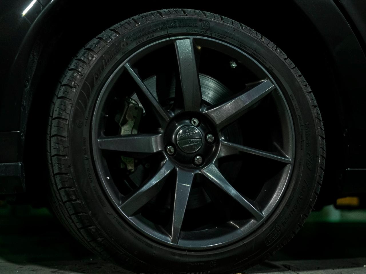 Wheel, tire tread, and brake assembly under an inspection lamp